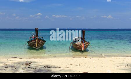 Krabi, Thailand - März 29 2019: Traditionelles Holz-Langschwanz-Boot in tirquesischem blauem Wasser, weiße Sandinsel Stockfoto