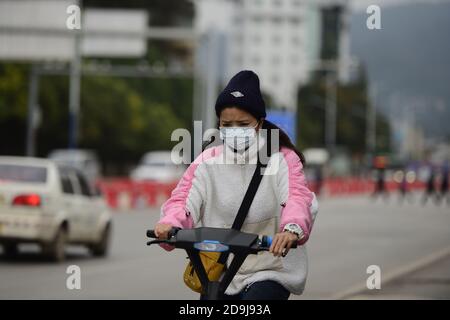 Bürger auf der Straße tragen Wintermantel als die Temperatur stark sinkt, wie die Saison ändert, Kunming Stadt, Südwesten Chinas¯s Yunnan Provinz, 19 O Stockfoto