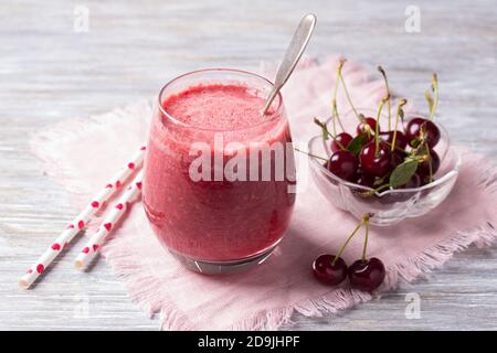 Kirsch-Smoothies mit frischen Kirschen auf einem Holztisch. Köstliche Ernährung gesundes Getränk, rustikalen Stil, selektive Konzentration Stockfoto