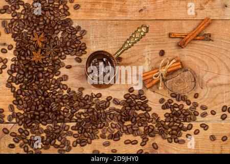 Türkische Kaffeemaschine und Kaffeebohnen auf rustikalem Holz Tabelle in einer Draufsicht Stockfoto