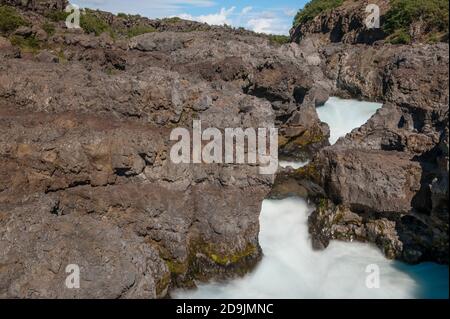 Barnafoss ist ein gefährlicher isländischer Wasserfall im Westen der Insel. Sie wird durch den Fluss Hvita gebildet, der durch eine enge Schlucht geht. Stockfoto