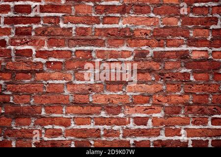 Alte Backsteinmauer. Horizontale breite rote Farbe Backstein Wand Hintergrund. Fassade des Vintage-Hauses Stockfoto