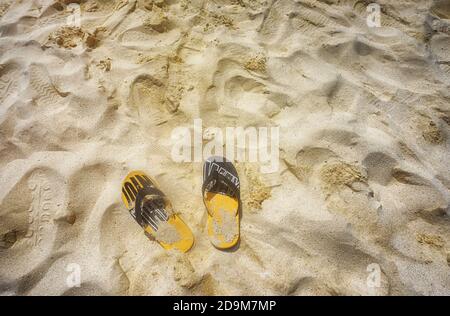 Badeschlappen auf dem goldenen Sand Stockfoto