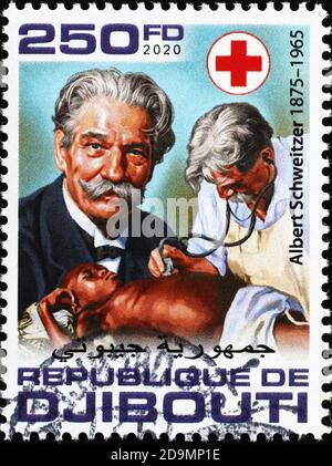 Albert Schweitzer untersucht ein Kind auf Briefmarke Stockfoto