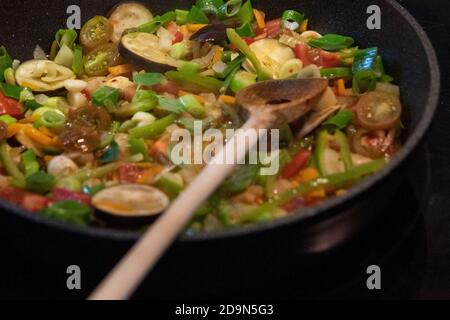 Auberginen ernten und vegetarisch kochen: Gesunde und nachhaltige Ernährung aus dem eigenen Garten. Vorbereitung der Gemüsesauce mit Auberginen. Stockfoto