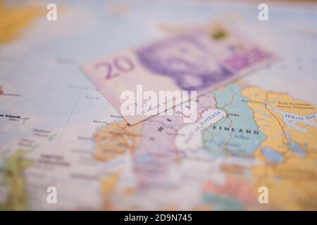 Zwanzig schwedische Kronen Rechnung über Schweden auf einem bunten und Verschwommene Europakarte Stockfoto