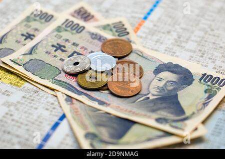 Kleiner Stapel von verschiedenen Denominationen von Yen auf einer Zeitung. Stockfoto