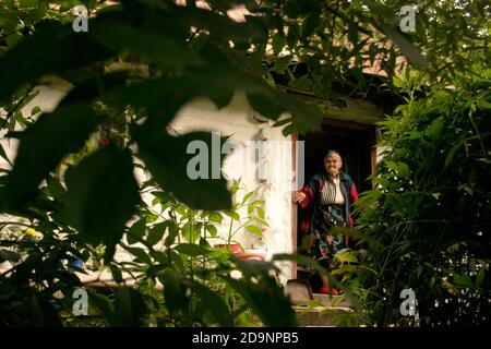 Ältere Frau an der Haustür in Rumäniens Land Stockfoto