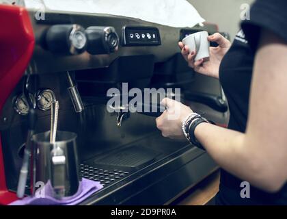 Nahaufnahme des Barista mit der Kaffeemaschine in der Bar Stockfoto
