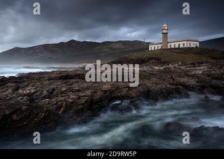 Leuchtturm auf der Klippe mit einem dramatischen Himmel und wild Wasser in der Nähe Stockfoto