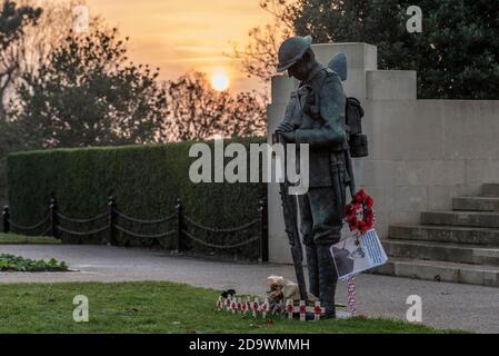 Southend on Sea, Essex, Großbritannien. November 2020. Die Sonne geht am Sonntagmorgen der Erinnerung auf, hinter dem Southend Cenotaph und dem Kriegsdenkmal. Eine bronzene „Tommy“-Figur ist eine jüngste Ergänzung, die auf Ruheleuchten steht. Am Morgen Stockfoto