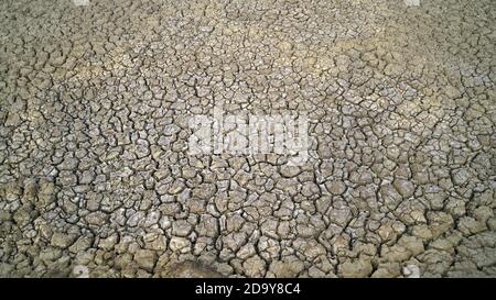 Globale Erwärmung Problem geknackt Erde und trockenes Wasser ist weicher Fokus, Vollbildaufnahme von geknacktem Land, Bodenstruktur, verblasst, schwache Reds Stockfoto