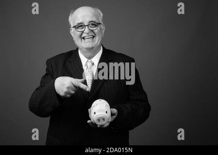 Übergewichtiger Geschäftsmann mit Brillen vor braunem Hintergrund Stockfoto