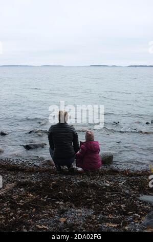 Mutter und Tochter blicken auf das Meer. Värmdö, Stockholm. Das Archipel im Hintergrund. Stockfoto