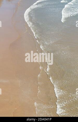 Abstrakter Hintergrund mit der Wasserwelle am Sandstrand Stockfoto