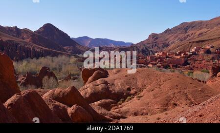 Panoramablick auf die unteren Schluchten von Dadès bei Boumalne Dadès, Marokko mit roten Felsformationen und einem Berberdorf am Fuße des Atlas. Stockfoto