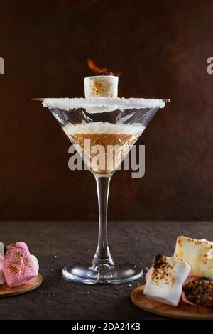 Irischer Cremelikör in einem martini-Glas mit Marshmallows mit Feuer. Stockfoto