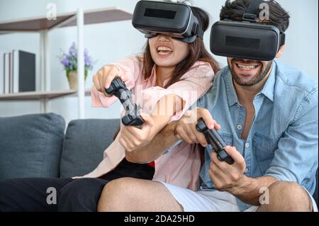 Paare Liebhaber genießen es, VR-Spiel zusammen zu Hause zu spielen. Familienbeziehungskonzept. Stockfoto