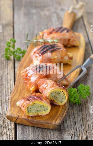 Gegrillte schwäbische Fleischravioli, sogenannte Maultaschen, eingewickelt in Käse und Speck, überzogen mit einer würzigen Grillsoße Stockfoto