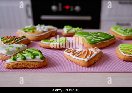 Kinder Lebkuchen handgefertigt. Kuchen mit Zuckerguss für Schulparty. Lebkuchen mit Zeichnungen in Form von Blumen und Herzen. Cookies von Händen von Chi Stockfoto