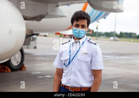 Ukraine, Kiew - 8. Juli 2020: Der Pilot, Kapitän und Flugbegleiter sind Personal, ein Team in medizinischen Masken. Maskierte Menschen bei der Arbeit. Der Mann arbeitet Stockfoto