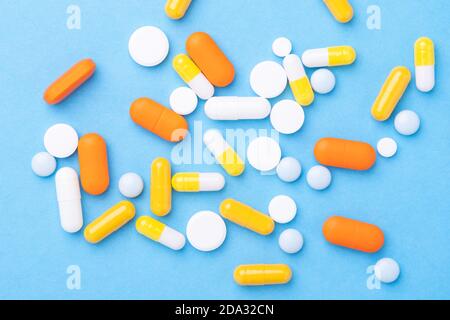 Mehrfarbige Tabletten und Pillen Kapseln auf blauem Hintergrund Close-Up Top Ansicht - Bild Stockfoto