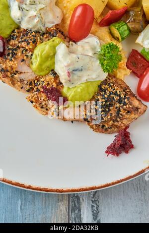 Gegrilltes Hähnchen mit Sesam neben gegrilltem Gemüse auf Holz Tabelle Stockfoto