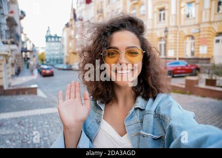 Glückliche hispanische junge Frau mit Videokonferenz mit Handy im Freien. Stockfoto