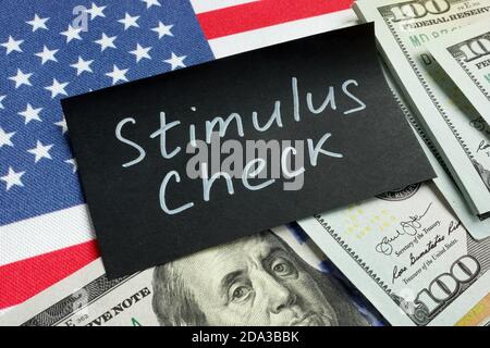 Stimulus Check Wörter, Geld und USA Flagge. Stockfoto