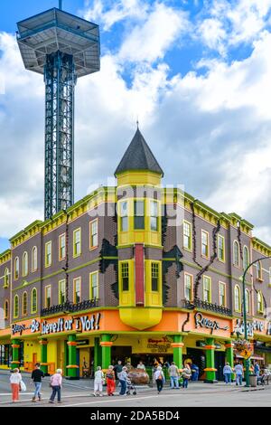 Die Gatlingburg Space Needle ragt über die Innenstadt von Gatlinburg, TN, mit Menschen, die Attraktionen genießen, wie Ripley's glauben, es ist whacky, bunt Stockfoto