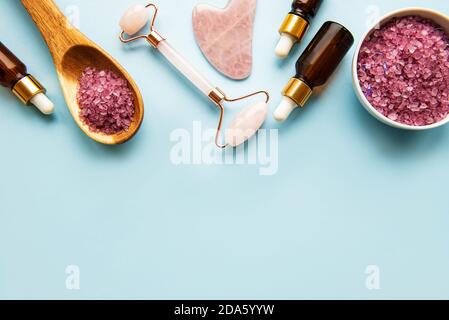 Natürliche Bio-WELLNESS-Kosmetik mit Lavendel. Flach Lay Badesalz, Spa-Produkte und Lavendelblüten auf blauem Hintergrund. Hautpflege, Schönheitsbehandlung Konz Stockfoto