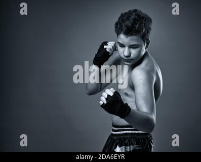 Junge Kickboxer mit Händen gewickelt Training, monochrom getönten Bild Stockfoto