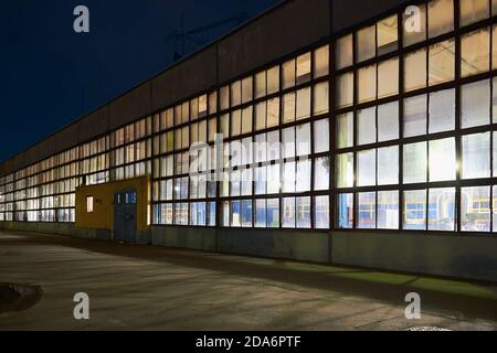 Nachtpanorama des Chemieanlagenbaus mit dunkelblauem Himmel. Compression Gebäude Rückzugsperspektive, mit Copyspace. Stockfoto