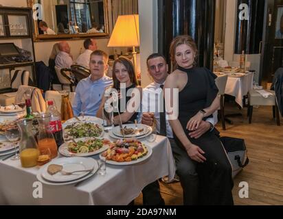 Eine Gruppe von Freunden, die im Restaurant sitzen und zu Abend essen, London, Großbritannien Stockfoto