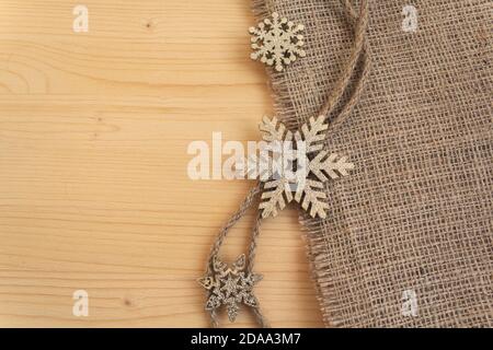 Stilisierte Schneeflocken auf einem Holz- Oberfläche. Weihnachtsschmuck Stockfoto