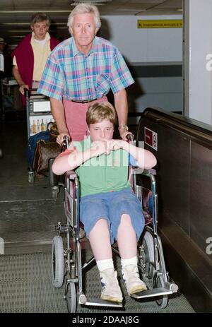 TV-Moderator Michael Aspel und sein behinderter Sohn Patrick AT Flughafen London Heathrow 1990 Stockfoto