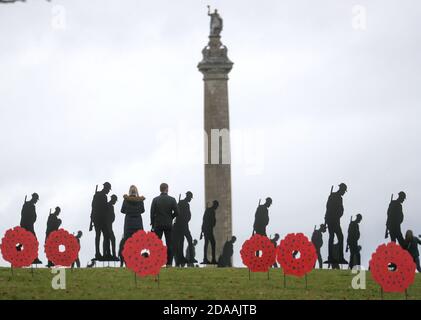 In Blenheim Palace Gardens in Woodstock, Oxfordshire, stehen Menschen unter zweihundert Silhouetten von Soldaten, die der Witney-Künstler Dan Barton geschaffen hat, um an die Kriegstoten am Waffenstillstandstag zu erinnern. Stockfoto