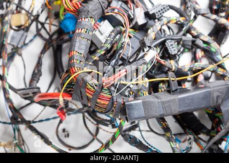Bündel von verwickelten Drähten in verschiedenen Farben, Typen und Größen mit aufgewickelten Isolierung und Anschlüssen auf einem weißen Hintergrund im Fotostudio. Remote-Arbeit Stockfoto