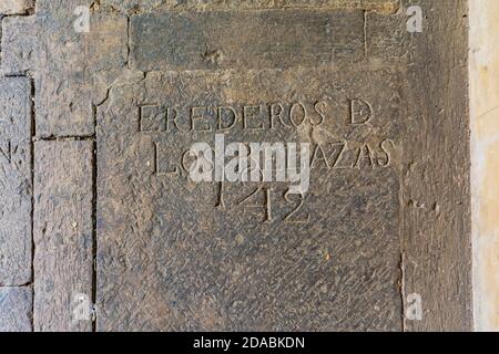 Stein im Kreuzgang mit der Inschrift "geerbt von den Belazas, 1212". Kirche Santa María. Los Arcos, Navarra, Spanien, Europa Stockfoto