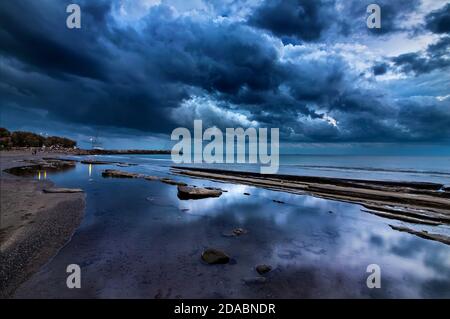 Ein Strand in Ierapetra Stadt (Lassithi, Kreta, Griechenland), direkt nach Sonnenuntergang, am Rande von zwei Jahreszeiten, Ende des Sommers, Anfang des Herbstes. Stockfoto