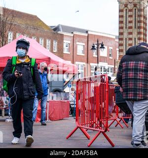 London UK, November 12 2020, Uber Eats Delivery Person Spaziergang durch einen Outdoor-Markt liefern Lebensmittel Stockfoto