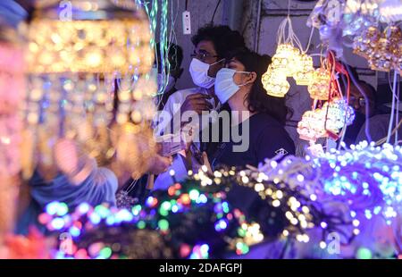 Mumbai, Indien. November 2020. Die Inder schauen auf elektrische Lichter auf einem Markt vor Diwali, dem hinduistischen Lichterfest, inmitten der Verbreitung des COVID-19 in Mumbai, Indien, am 12. November 2020. Quelle: Fariha Farooqui/Xinhua/Alamy Live News Stockfoto