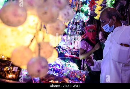 Mumbai, Indien. November 2020. Die Inder schauen auf elektrische Lichter auf einem Markt vor Diwali, dem hinduistischen Lichterfest, inmitten der Verbreitung des COVID-19 in Mumbai, Indien, am 12. November 2020. Quelle: Fariha Farooqui/Xinhua/Alamy Live News Stockfoto