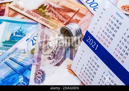 Kalender und russisches Geld, Glühbirne und Kalender, Lampe und Geld, russisches Geld Stockfoto