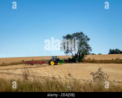 Ein Traktor pflügt ein Feld nach der Ernte in Mitte Suffolk, England Stockfoto