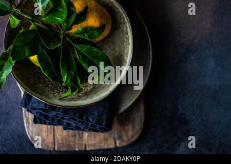 Ferienort Einstellung mit frischen Bio-Mandarinenfrüchten auf rustikal Hintergrund mit Kopierbereich Stockfoto