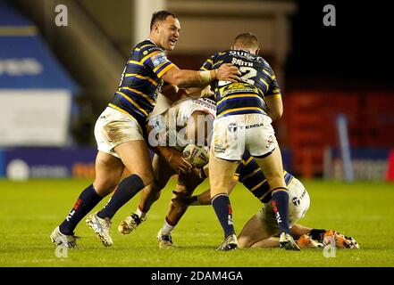 Sam Moa von Catalans Dragons (Mitte) wird von Matt Prior von Leeds Rhinos (rechts) während des Betfred Super League Play-Off-Spiels im Halliwell Jones Stadium, Warrington, angegangen. Stockfoto