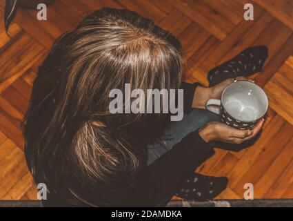 Schwarz-Weiß-Foto einer Frau, die einen leeren hält becher Stockfoto