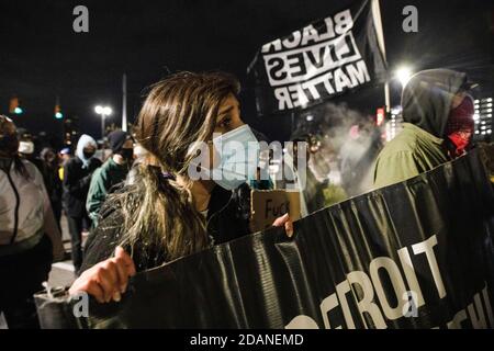 Demonstranten, die Masken tragen, stehen vor der Wayne County Gaol Division I. Detroit will Breathe, eine Aktivistengruppe gegen Polizeibrutalität und für Black Lives, organisierte einen "Chief Craig Resigns"-nachtmarsch in der Innenstadt von Detroit. Dieser besondere Protest konzentrierte sich auf die Behandlung von rechten Demonstranten, die in Detroit eindrangen, um die Stimmenauszählung im TCF-Zentrum am Tag nach der Wahl zu stoppen. Detroit will Breathe behauptet, ihre friedlichen Demonstranten seien von der Polizei von Detroit ins Krankenhaus geschickt worden, während die rechten Demonstranten in Detroit willkommen geheißen wurden. Stockfoto