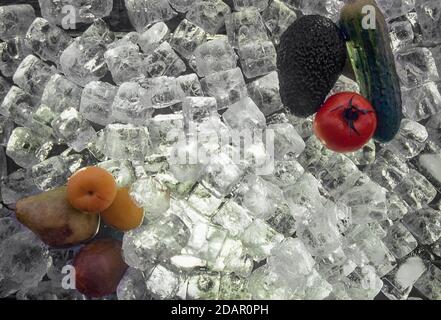 Stillleben von Obst, Gemüse, Birnen, Aprikosen, Avocado, Gurkentomate und Eiswürfel Stockfoto